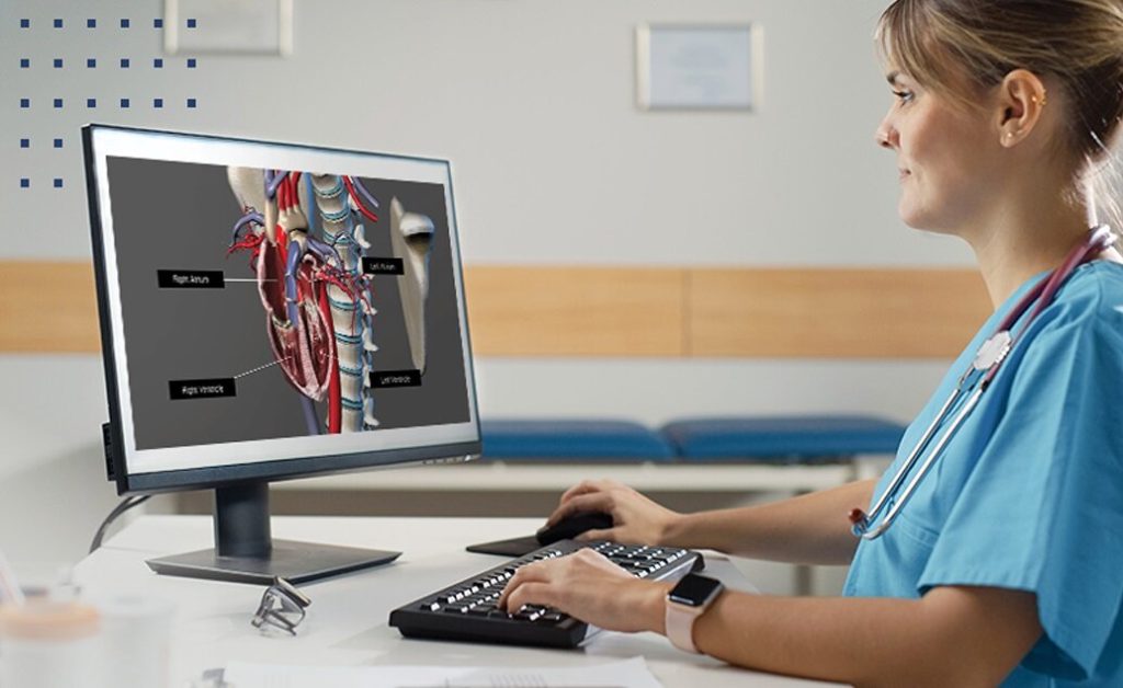 Female nurse looking at a medical image on a computer.