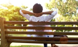 Person relaxing on a park bench.