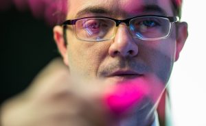 close-up of Dan Jones writing on the photo lens