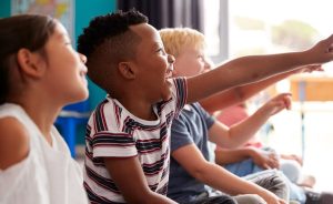 A group of excited children pointing.