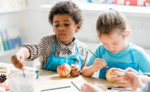 Two children painting at a table.
