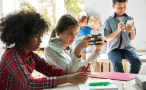 Young students using digital devices at school