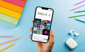 Image of the DALL-E 2 app interface on a smartphone, showing a grid of AI-generated images.