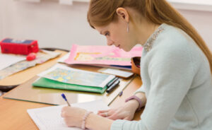 Woman grading school work at desk.